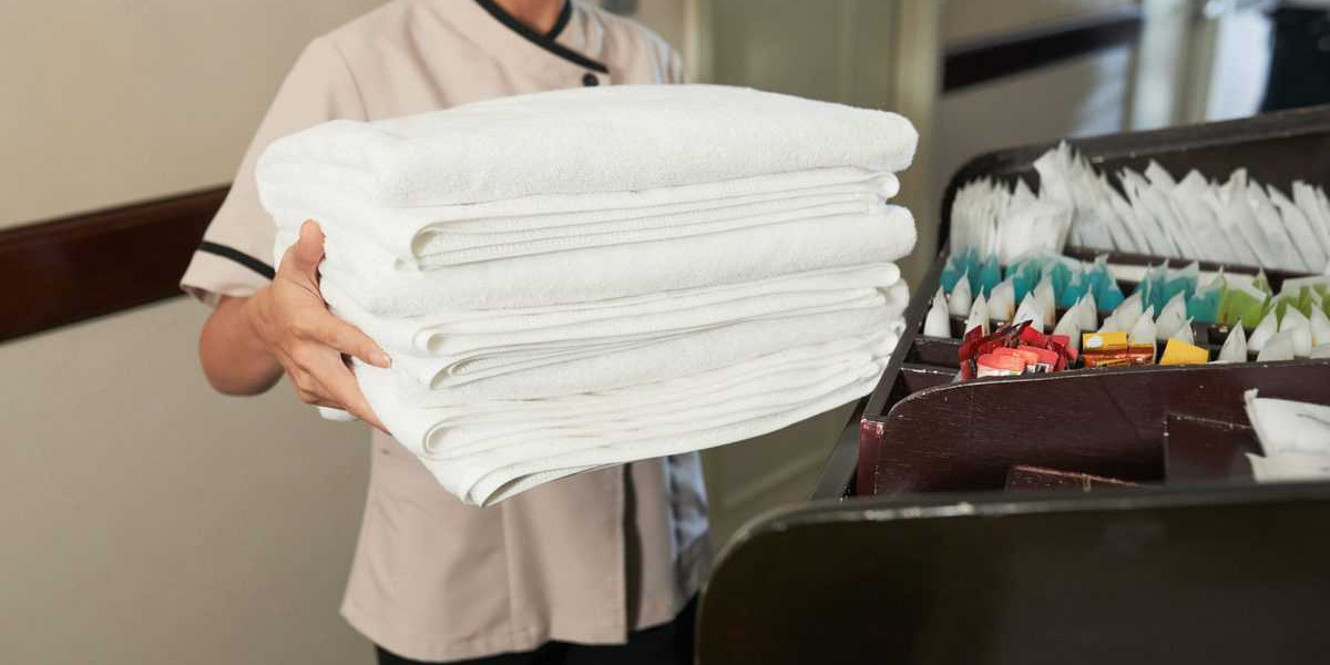 chambermaid with pile of fresh towels