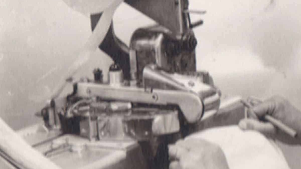 A man working on a sewing machine.